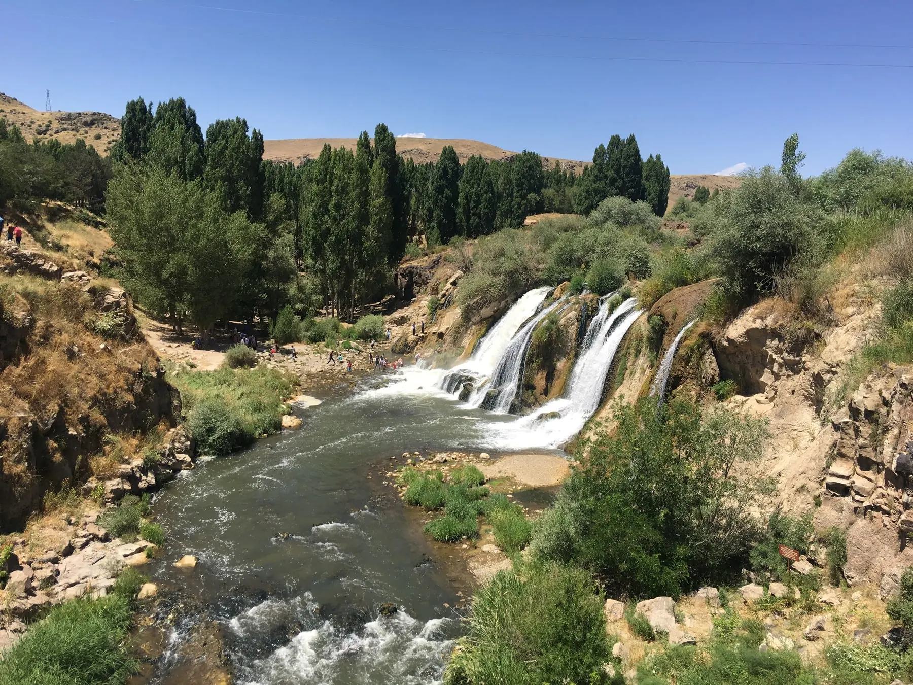 Muradiye Waterfall cascading over rocks surrounded by trees